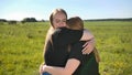 Portrait of hugging two twin sisters in the field on a warm summer day Royalty Free Stock Photo