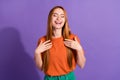 Portrait of humorous girlfriend red hair model touching chest and laughing closed eyes when listen joke isolated on Royalty Free Stock Photo