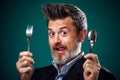 A portrait of hungry man in suit holding spoon and fork Royalty Free Stock Photo