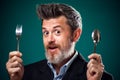 A portrait of hungry man in suit holding spoon and fork Royalty Free Stock Photo