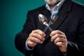 A portrait of hungry man in suit holding spoon and fork Royalty Free Stock Photo