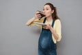 Portrait of a hungry pregnant woman eating sweet chocolate cake Royalty Free Stock Photo