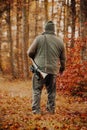 Portrait of hunter or ranger with gun or rifle in the forest looking out or hunting of some venison, hunting period Royalty Free Stock Photo