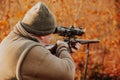 Portrait of hunter or ranger with gun or rifle in the forest looking out or hunting of some venison, hunting period Royalty Free Stock Photo