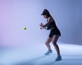 Young tennis player preparing to make forehand shot.