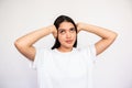 Portrait of ignorant young woman covering ears with hands