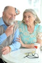 Portrait of ill senior couple with inhaler