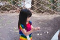 Portrait image Asian child 4 years old. Cute kid are playing raffle activities. Children sweat on face due to hot weather.