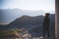 Portrait image of a beautiful Asian woman standing on the top of view point with Leh city Royalty Free Stock Photo