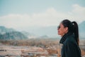 Portrait image of a beautiful Asian woman standing on the top of view point with Leh city Royalty Free Stock Photo