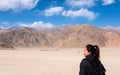 Portrait image of a beautiful Asian woman tourist standing in front of mountain Royalty Free Stock Photo