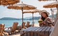 A beautiful young asian woman holding and drinking coconut juice on the beach Royalty Free Stock Photo