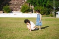 Portrait image child 5-6 year old. Children playing on lawn. Kid are interested in small insects perched on top of green grass.