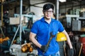 Portrait image engineer men wearing uniform safety and holding wrench tool in factory.