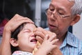 Portrait image family. Father comforting son who is crying heavily due to forehead injury.