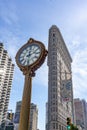 New York, NY - Vertical view of the famous Flatiron Building with a historic Street clock in the foreground.