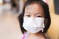 Portrait image of 5-6 years old childhood. Happy Asian child girl smiling and wearing white face mask. Protection air pollution Royalty Free Stock Photo