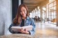 A young beautiful asian woman sitting and reading book Royalty Free Stock Photo