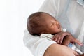 African, 12-day-old baby black skin newborn son, sleeping with his mother being held Royalty Free Stock Photo