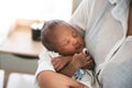 Portrait images of an African, 12-day-old baby newborn son, sleeping with his mother being held Royalty Free Stock Photo