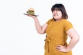 Portrait images of Asian attractive fat woman, are happy, smile and holding hamburger Royalty Free Stock Photo