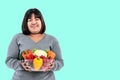 Asian attractive fat woman holding glass bowl  contains fruit and fresh vegetables Royalty Free Stock Photo