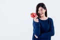 attractive woman is good shape, holding and looking at a red vegetable, bell pepper Royalty Free Stock Photo