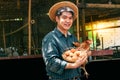 Portrait images of Asian farmers are carrying hens and wicker basket with fresh eggs