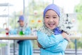 Portrait images of Asian girl 4 year old wearing a blue Islamic dress