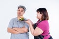Portrait images of Asian wife Obese persuading her husband To eat a hamburger