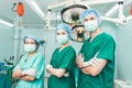 A team of Asian doctors, male and female surgeons Standing in the operating room