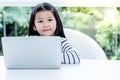 Portrait images of A 6 year old Asian girl are smile and happy while using notebook Royalty Free Stock Photo