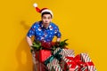 Portrait of impressed crazy person open mouth pile stack festive gifts market trolley isolated on yellow color