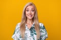 Portrait of impressed funny nice girl with long hairstyle wear flower print blouse staring biting lip isolated on yellow