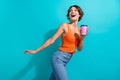 Portrait of impressed pretty girl wear orange knit top hold cup of coffee look at sale empty space  on blue Royalty Free Stock Photo