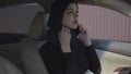 Portrait of independent young muslim woman sitting in her car lookiing to herself in mirrir and talking by the