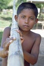 Portrait Indian boy trudging with bamboo pole Royalty Free Stock Photo