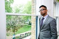 Portrait of Indian Businessman wearing glasses standing by the window