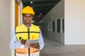 portrait indian engineer forman staff worker standing happy smiling in cargo factory indoor with tablet