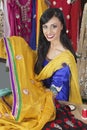 Portrait of an Indian female dressmaker holding sari