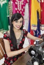 Portrait of an Indian female dressmaker using sewing machine