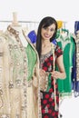 Portrait of an Indian female dressmaker working on traditional outfit