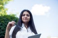 portrait of an indian girl. Business lady holding glasses and tablet in her hands. Outdoors Royalty Free Stock Photo