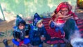 Portrait of indian grand mother sitting with their grand children at home. Aged woman talking on the phone to her son Royalty Free Stock Photo