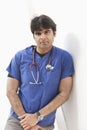 Portrait of an Indian male doctor leaning over white background