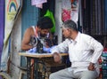 Portrait of Indian man tailor at work place