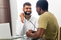 Portrait of indian man doctor talking to patient on consultation Royalty Free Stock Photo