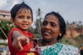 Portrait indian mother with child on Varkala during puja ceremony