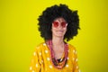 Portrait of an indian smiling girl with afro curly hairstyle on yellow background Royalty Free Stock Photo