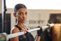 Portrait, Indian woman or bodybuilder with barbell in fitness training, workout or exercise for body building. Strong Royalty Free Stock Photo